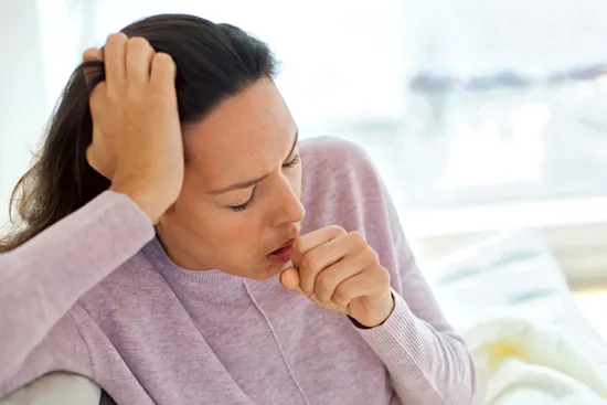 photo of young woman coughing